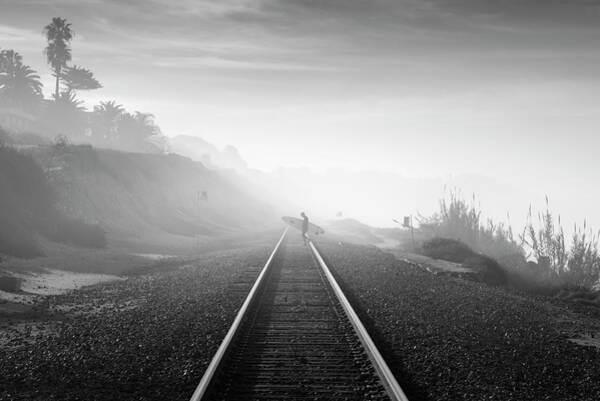 Surfer Walking Along Foggy Tracks Art Print
