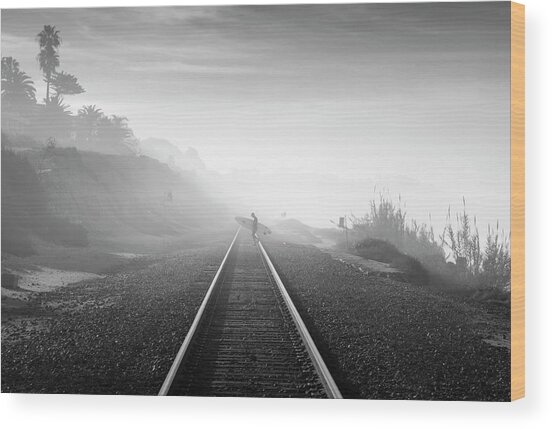 Surfer Walking Along Foggy Tracks Wood Print